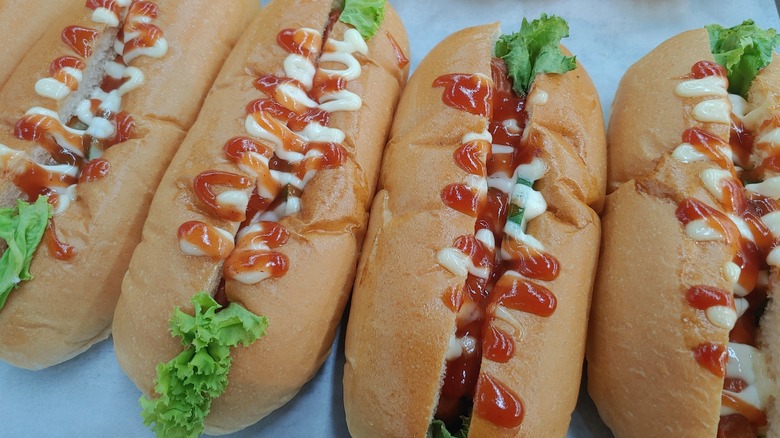 hot dogs with lettuce and sauces