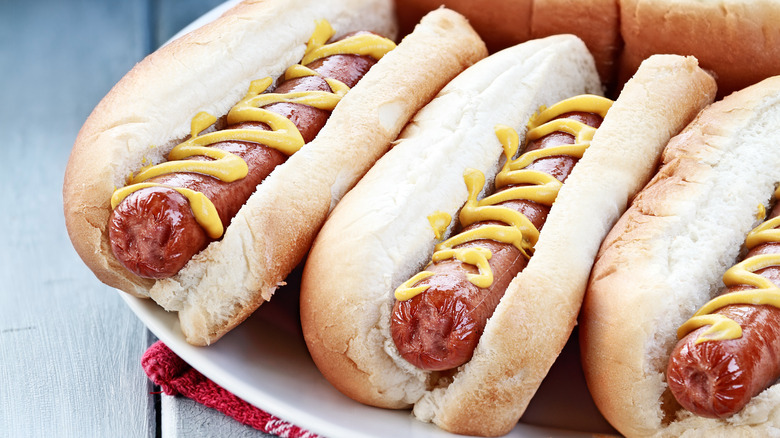 hot dogs in buns with mustard