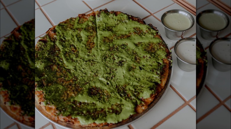 Green pizza with sauce