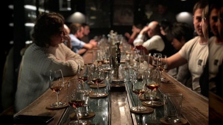 bar filled with glasses and people