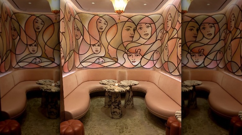 mural of faces and pink booth