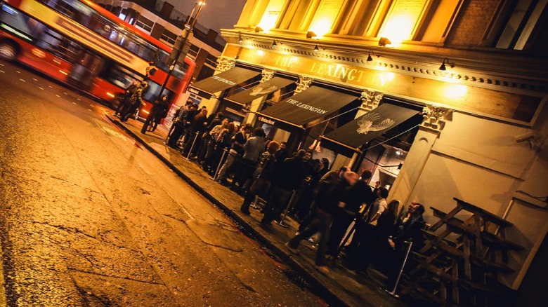 busy outdoor bar London bus