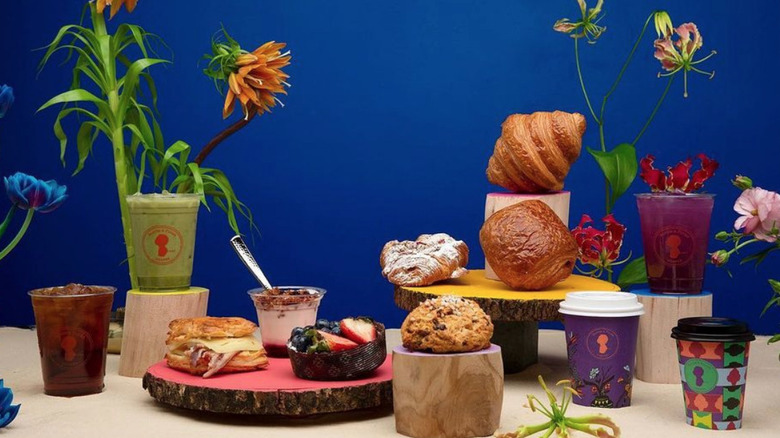 Coffee and pastries arranged with flowers