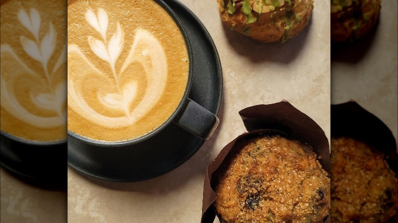 Cappuccino and muffin on table