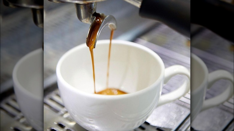 Espresso pouring into mug