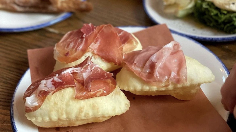 Cured meats on puffy bread
