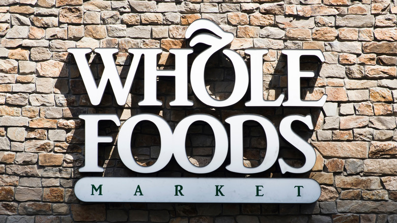 whole foods sign on stone wall