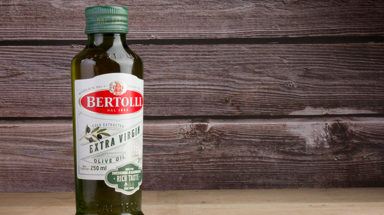 bertolli bottle in front of planks