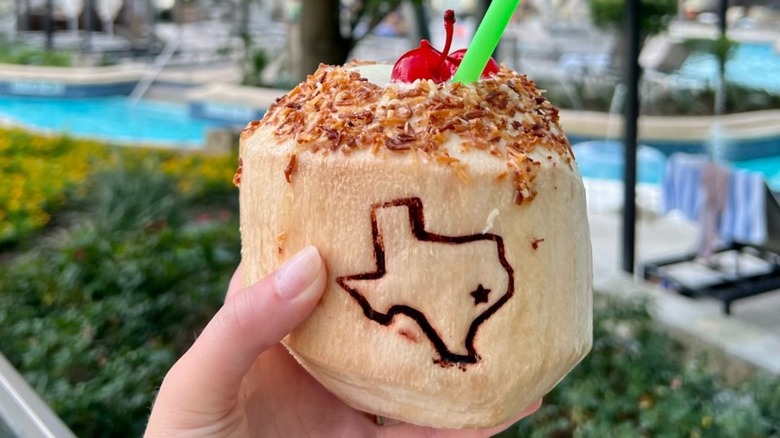 Poolside cocktail in coconut