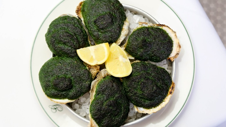 Oysters Rockefeller, white plate, table