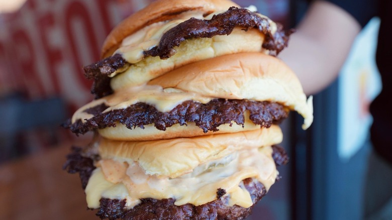 three cheesy smash burgers 