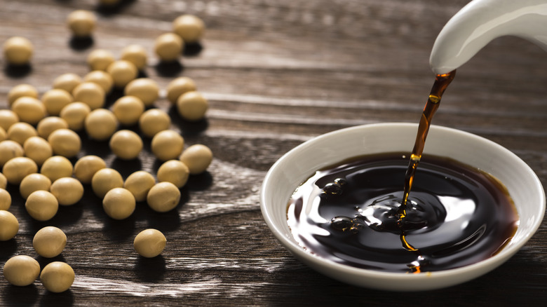 pouring soy sauce into bowl