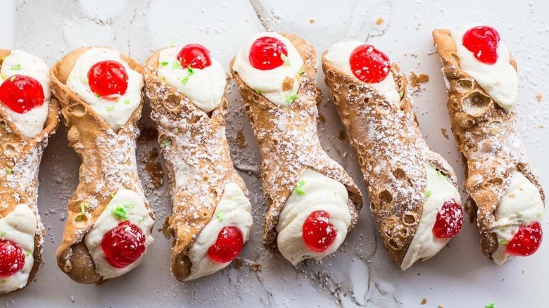 Line of cannoli with cherries