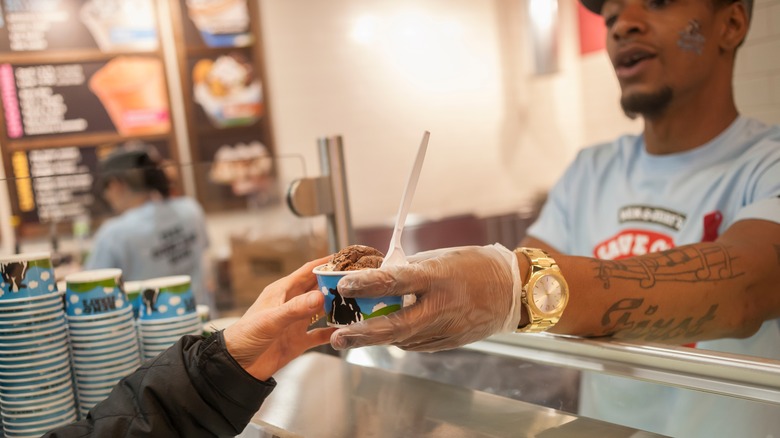 Ben and Jerry's employee helping customer