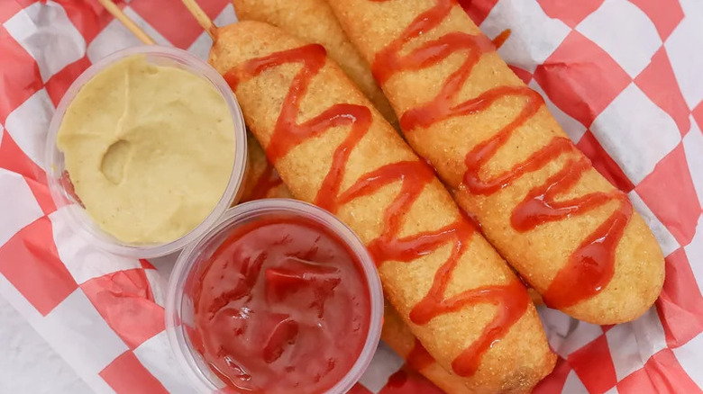 Piled corn dogs and sauces