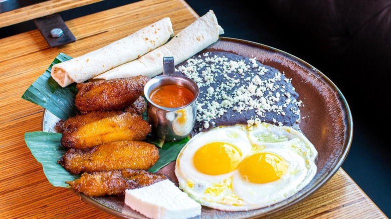 Breakfast plate with plantains eggs tortillas