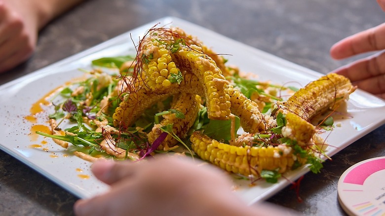 Corn ribs drizzled with greens