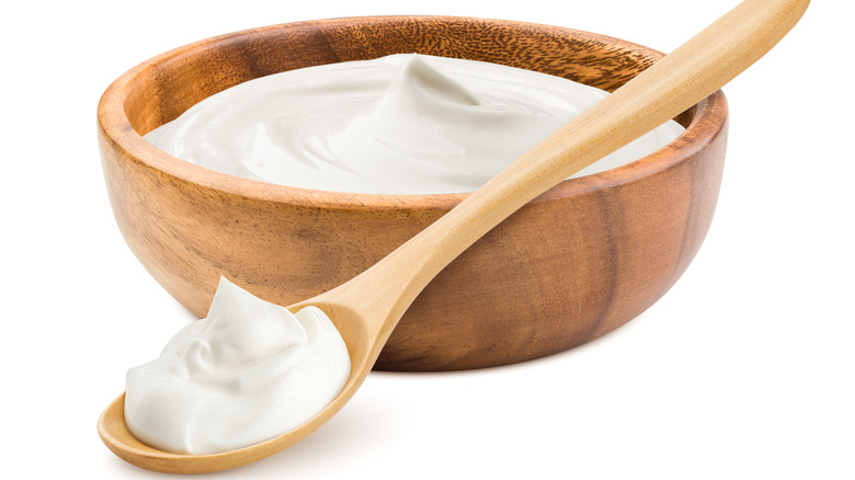 sour cream in wooden bowl