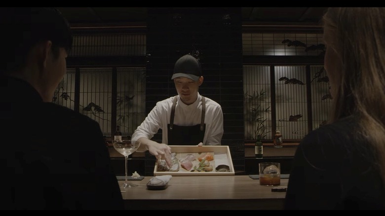 Chef displays sashimi to guests