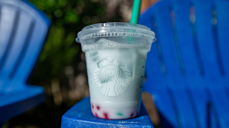 Starbucks' Summer Skies beverage outside on a lounge chair arm