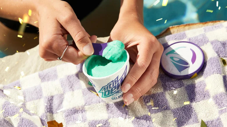 Person spooning out Taco Bell's Baja Blast gelato