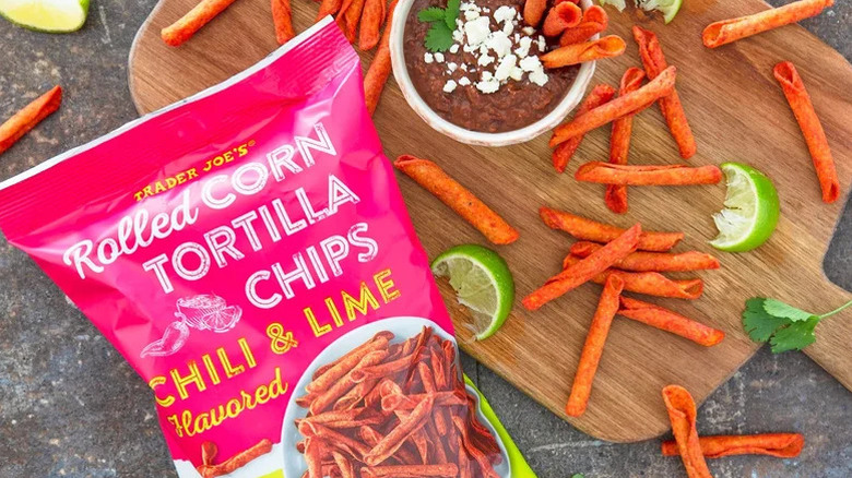 Trader Joe's chili and lime-flavored chips bag, with chips and dip on a cutting board