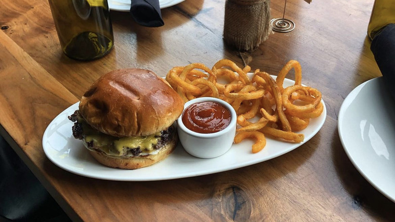 Cheeseburger with curly fries and ketchup