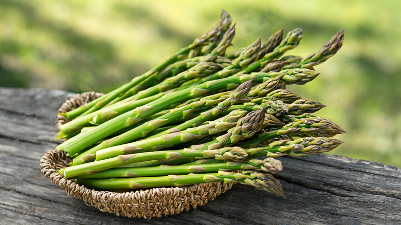Green asparagus in basket