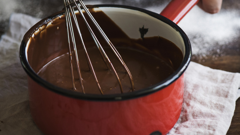 whisk in pot with chocolate