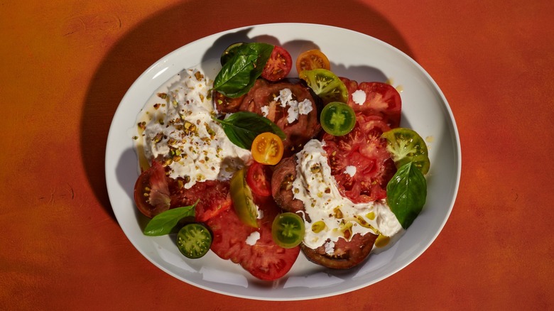 Stracciatella cheese on tomatoes