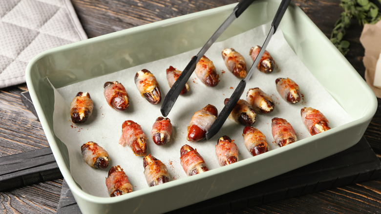 bacon-wrapped dates in baking dish