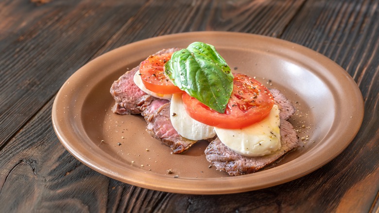 Steak with mozzarella, tomatoes, and basil