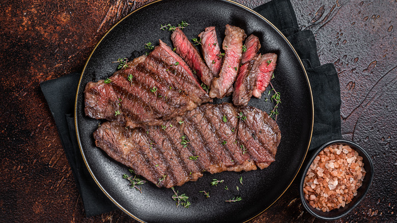 Plate of sliced steak and salt