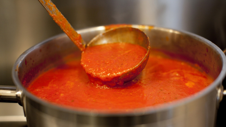 Pot and ladle of tomato soup