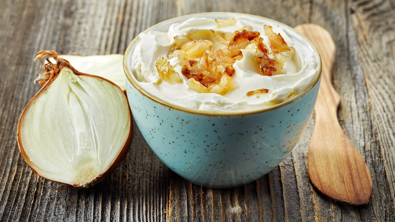 Bowl of homemade onion dip topped with caramelized onions