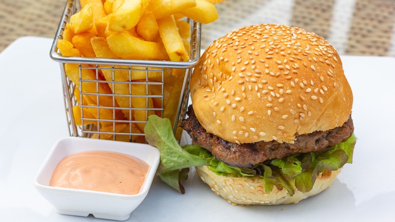 Burger and fries with dipping sauce 