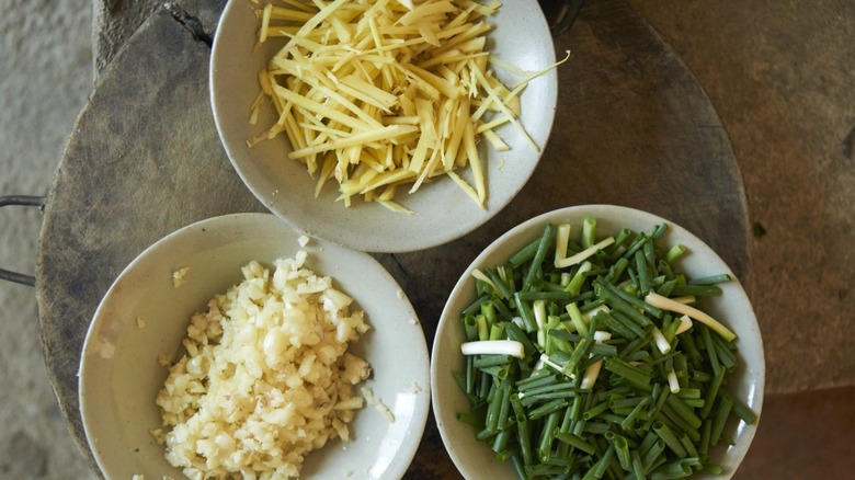 bowls of chopped ginger, garlic, and scallions