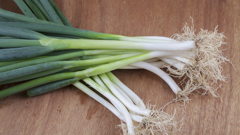 green onions on a wood table