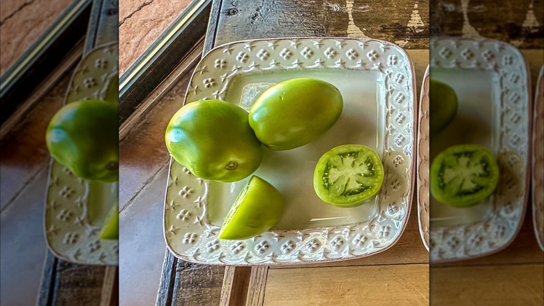 green tomato on a white plate