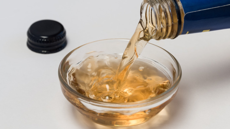 sherry vinegar being poured into glass ramekin