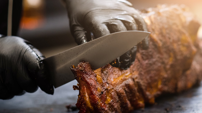 Chef cutting rack of ribs