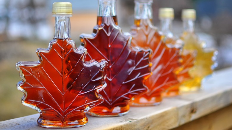 Colorful maple syrup grades in maple leaf bottles