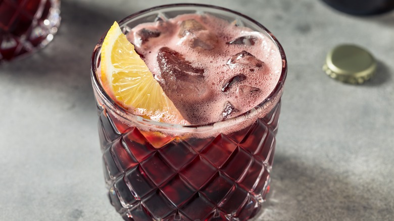 Kalimotxo cocktail with lemon garnish