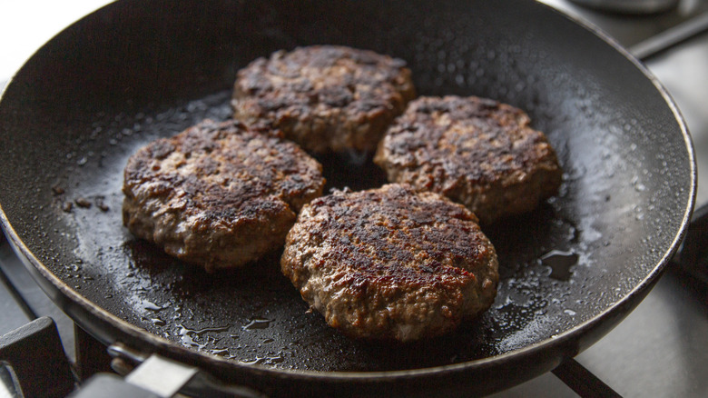 Burgers cooking in a pan