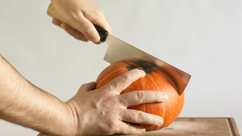 Nakiri knife cutting into pumpkin