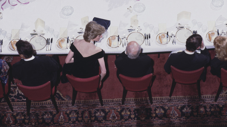 Princess Diana sits at banquet table