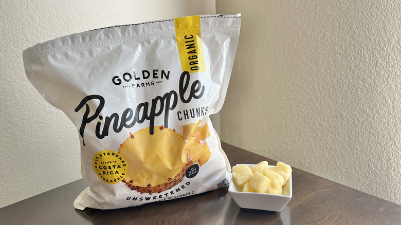 Bag of Golden Farms pineapple pieces on a wooden table