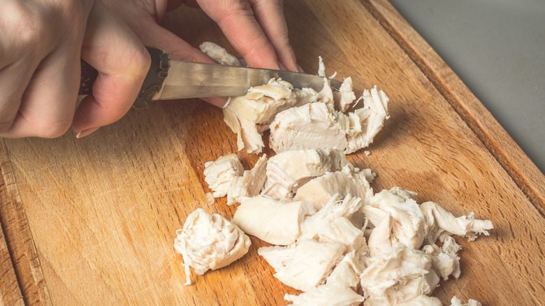 Chicken breast being diced