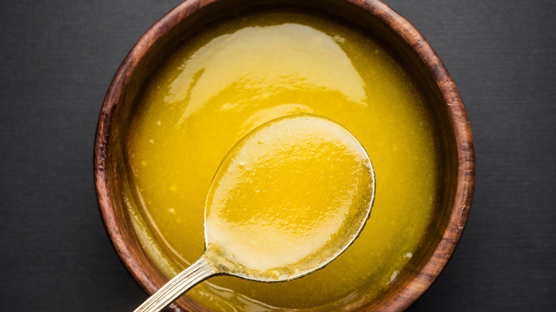 Ghee in wooden bowl with spoon