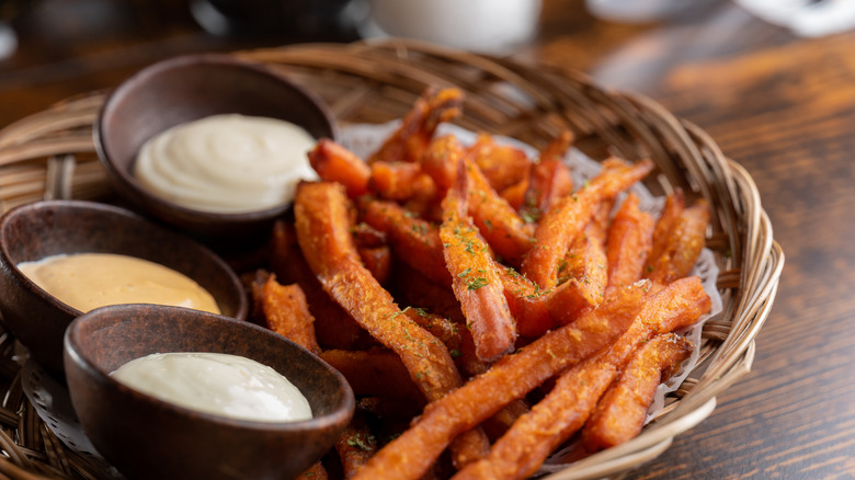 Basket of sweet potatio fries with dipping sauces